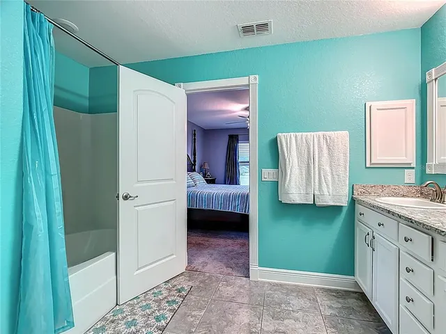 a en suite bathroom with a sink and a mirror