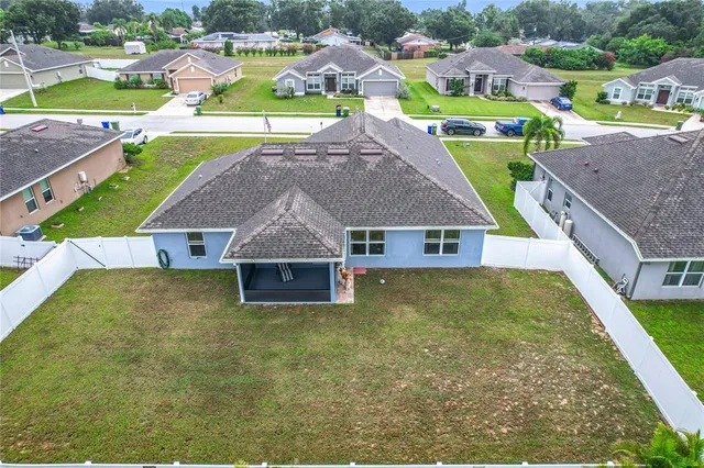 an aerial view of a house with a big yard