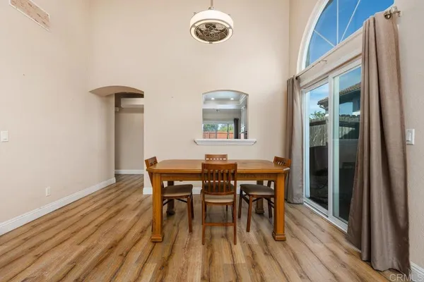 a dining room with furniture and wooden floor