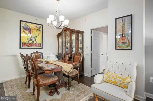 a view of a dining room with furniture and chandelier