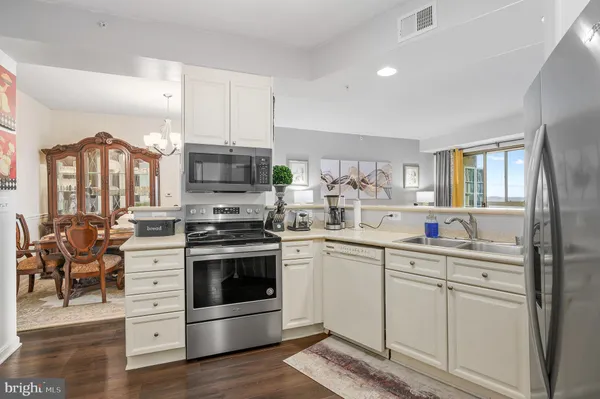 a kitchen with stainless steel appliances granite countertop a stove and a sink