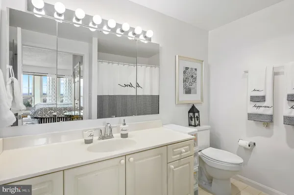 a bathroom with a sink a toilet and mirror