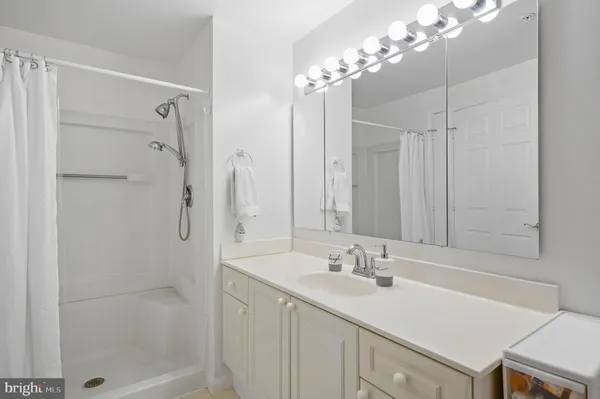 a bathroom with a sink double vanity and shower