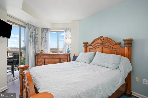 a bedroom with bed and glass windows