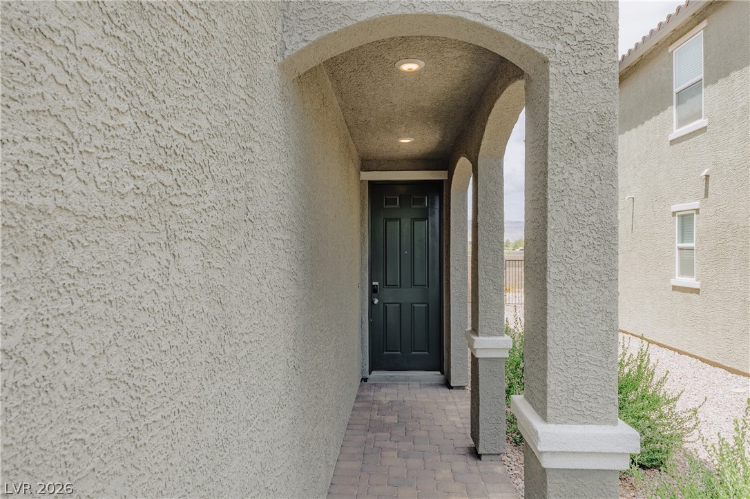 5927 Coja Street Las Vegas, NV 89113 - Photo 3 of 32 View of exterior entry with stucco siding