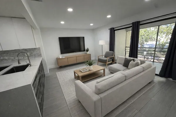 a living room with furniture and a flat screen tv