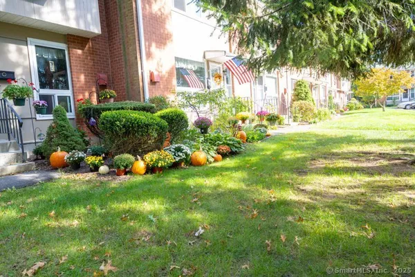 a view of a house with a backyard and a garden