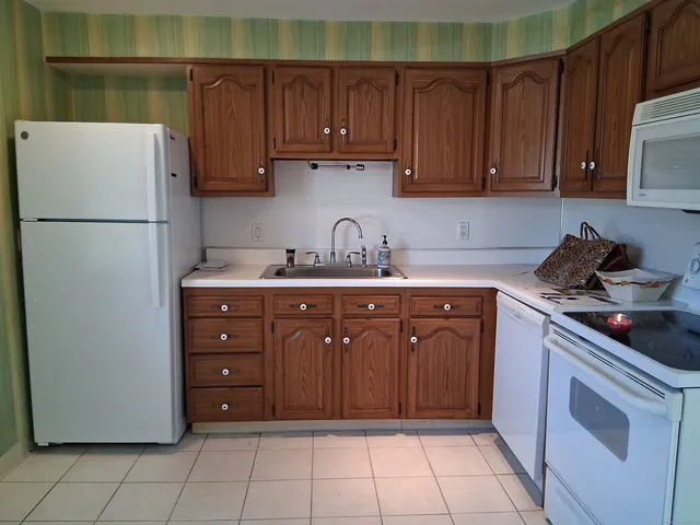 a kitchen with a refrigerator and cabinets