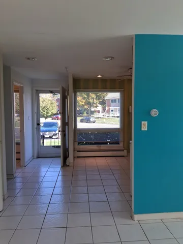 a view of a hallway with an empty room and window