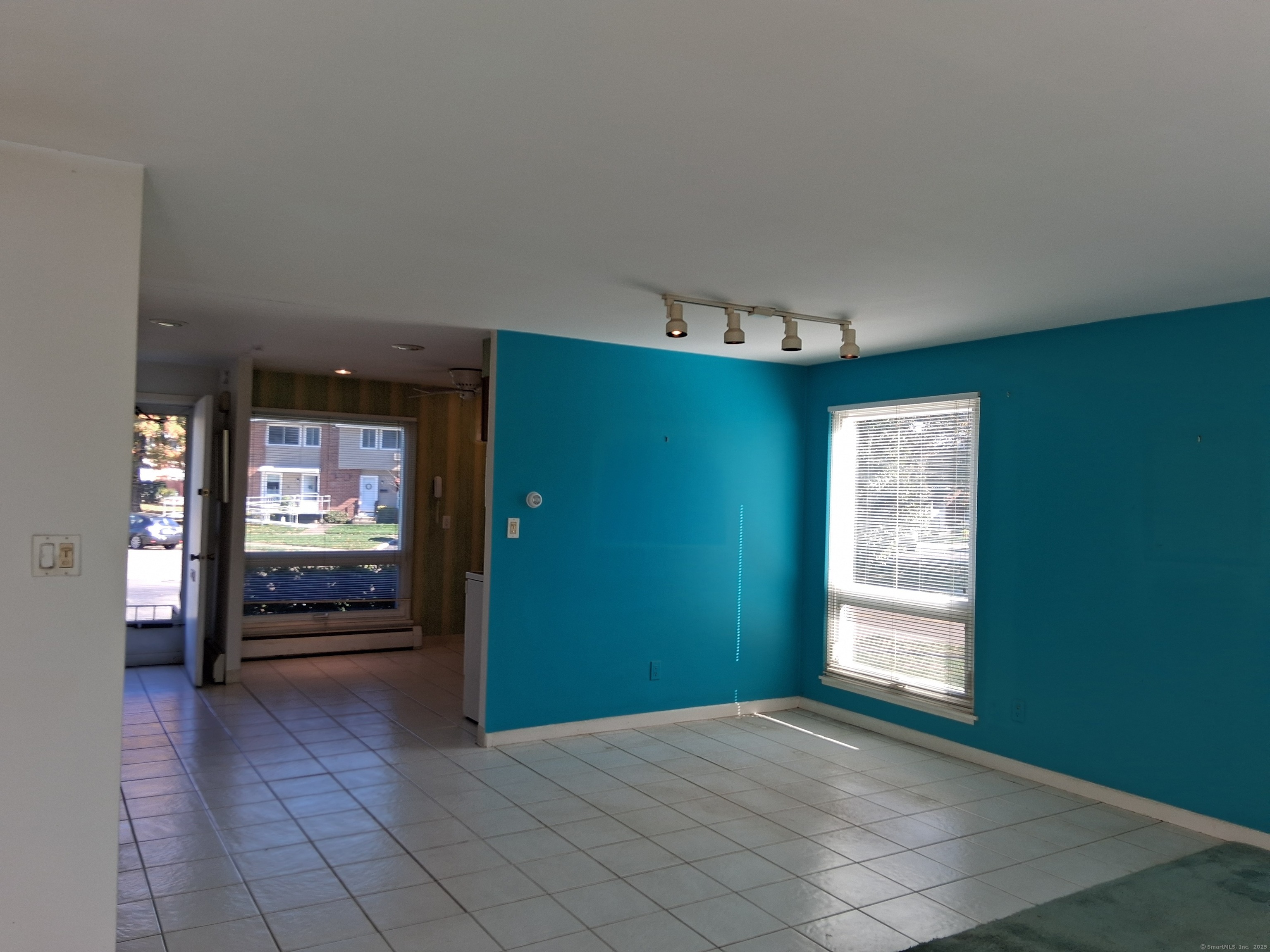 147 Centerbrook Road Hamden, CT 06518 - Photo 5 of 9 an empty room with kitchen and windows