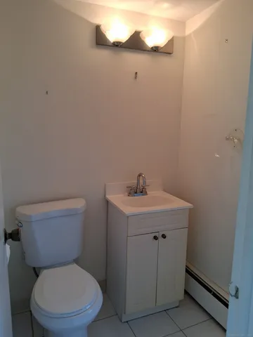 a white toilet sitting next to a bathroom sink