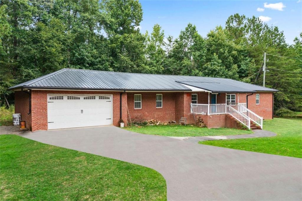 a aerial view of a house next to a yard and garage