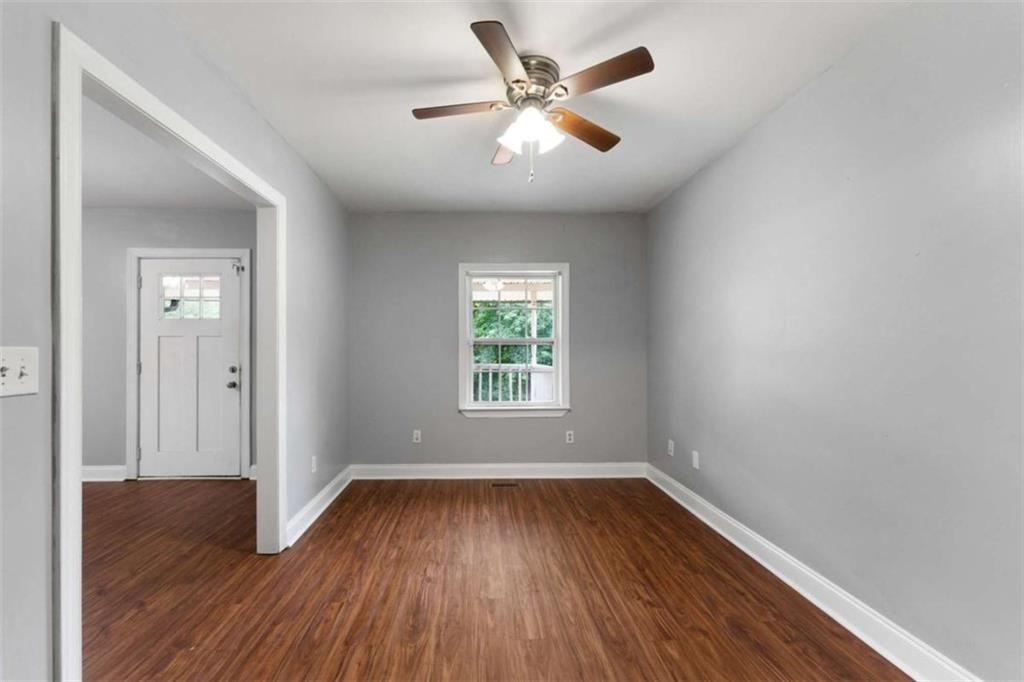159 Moores Ferry Road Southwest Plainville, GA 30733 - Photo 16 of 43 an empty room with wooden floor and windows