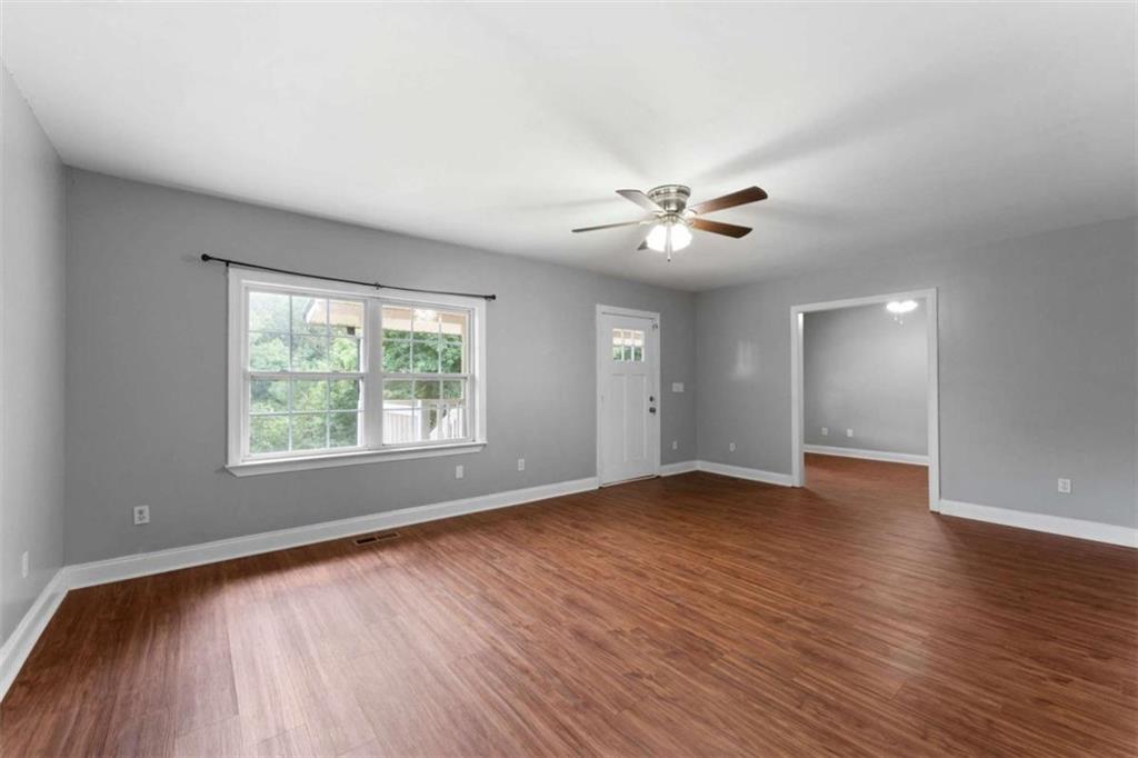159 Moores Ferry Road Southwest Plainville, GA 30733 - Photo 18 of 43 an empty room with wooden floor and windows
