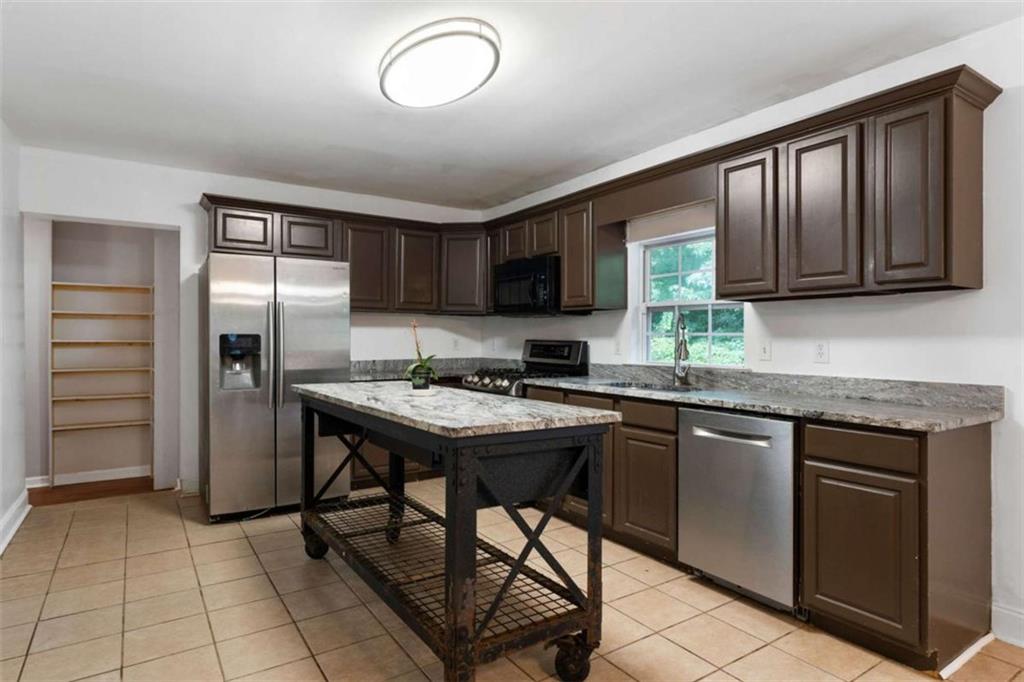 159 Moores Ferry Road Southwest Plainville, GA 30733 - Photo 22 of 43 a kitchen with stainless steel appliances granite countertop a stove refrigerator sink and cabinets