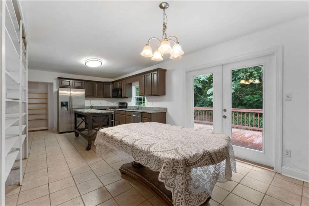 159 Moores Ferry Road Southwest Plainville, GA 30733 - Photo 25 of 43 a bedroom with a large bed and a view of kitchen