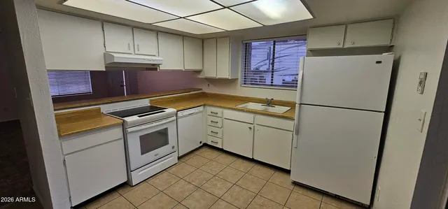 a kitchen with stainless steel appliances granite countertop a refrigerator sink and cabinets