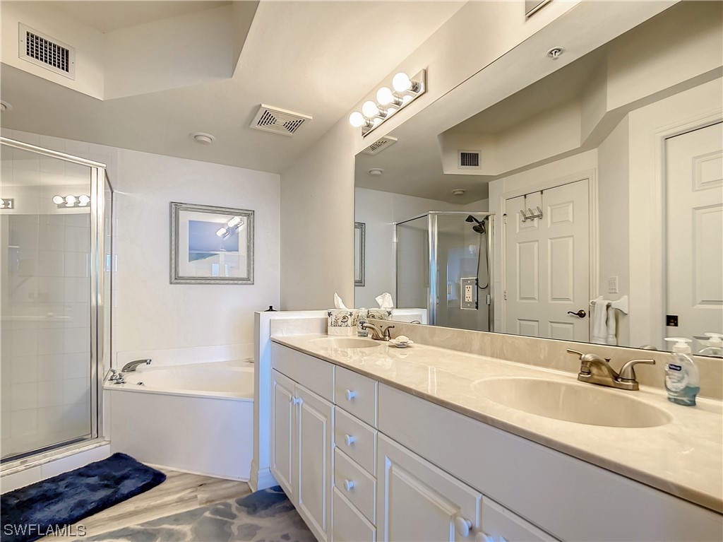 2797 First Street, Unit 1502 Fort Myers, FL 33916 - Photo 18 of 49 a bathroom with a sink double vanity granite tub and a mirror