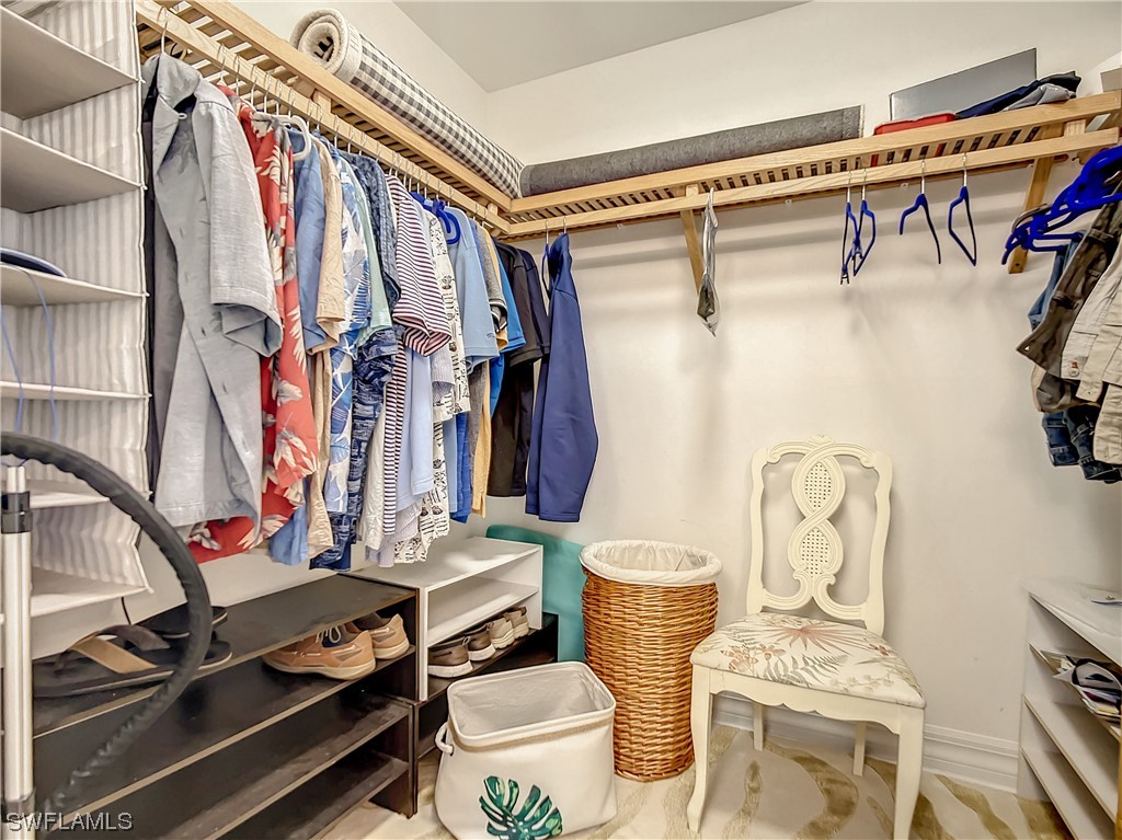 2797 First Street, Unit 1502 Fort Myers, FL 33916 - Photo 21 of 49 a view of walk in closet with clothes and shoes