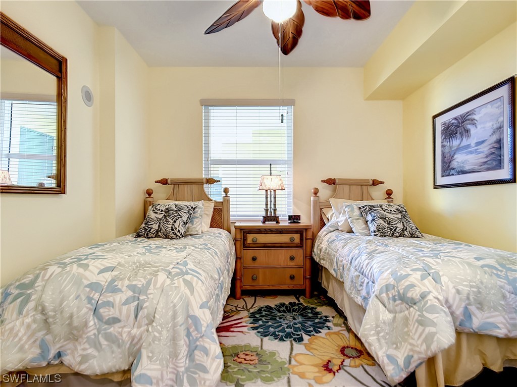 2797 First Street, Unit 1502 Fort Myers, FL 33916 - Photo 23 of 49 a bedroom with a bed and wooden floor