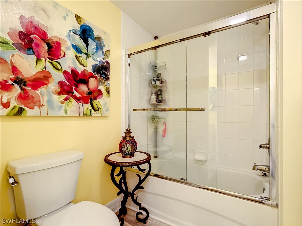 2797 First Street, Unit 1502 Fort Myers, FL 33916 - Photo 24 of 49 a bathroom with a shower curtain and a toilet