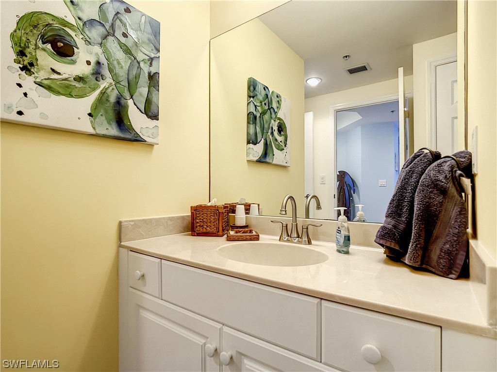 2797 First Street, Unit 1502 Fort Myers, FL 33916 - Photo 25 of 49 a bathroom with a sink and a mirror