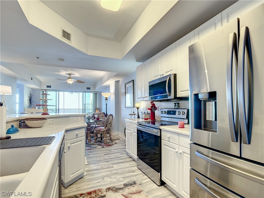 2797 First Street, Unit 1502 Fort Myers, FL 33916 - Photo 3 of 49 a kitchen with stainless steel appliances granite countertop a refrigerator stove and sink