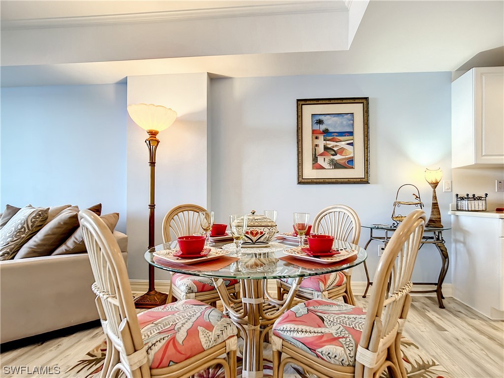 2797 First Street, Unit 1502 Fort Myers, FL 33916 - Photo 8 of 49 a dining room with furniture and wooden floor