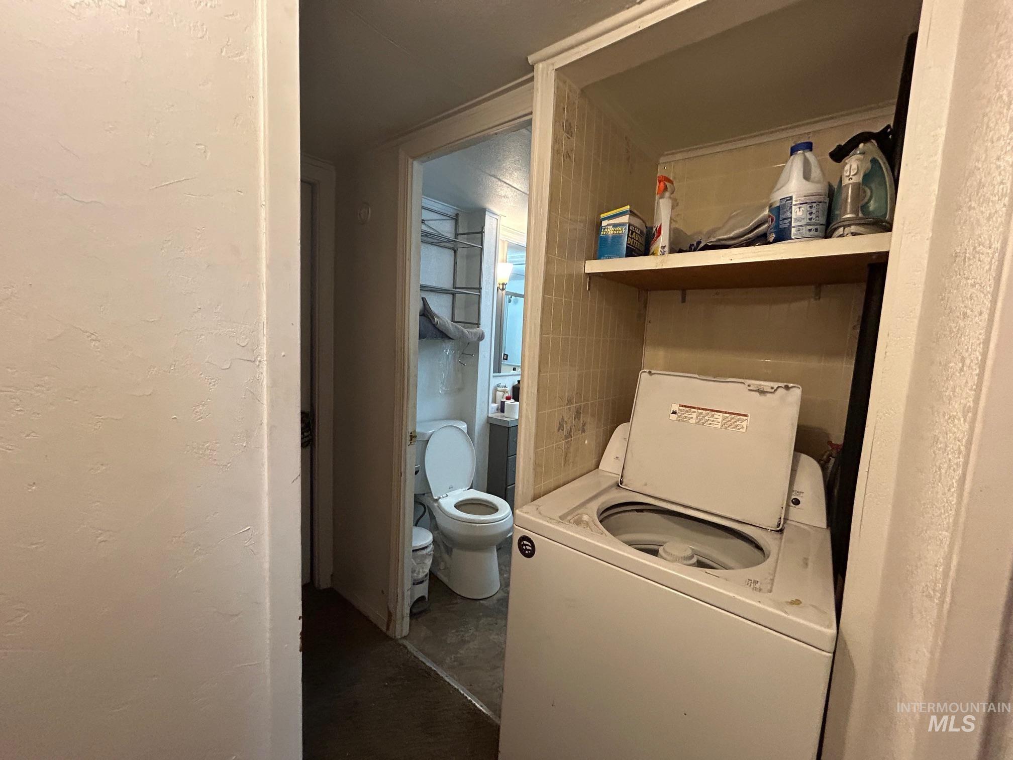 1383 Fair Street, Unit 7 Clarkston, WA 99403 - Photo 11 of 15 Laundry area with washer / clothes dryer and a textured wall