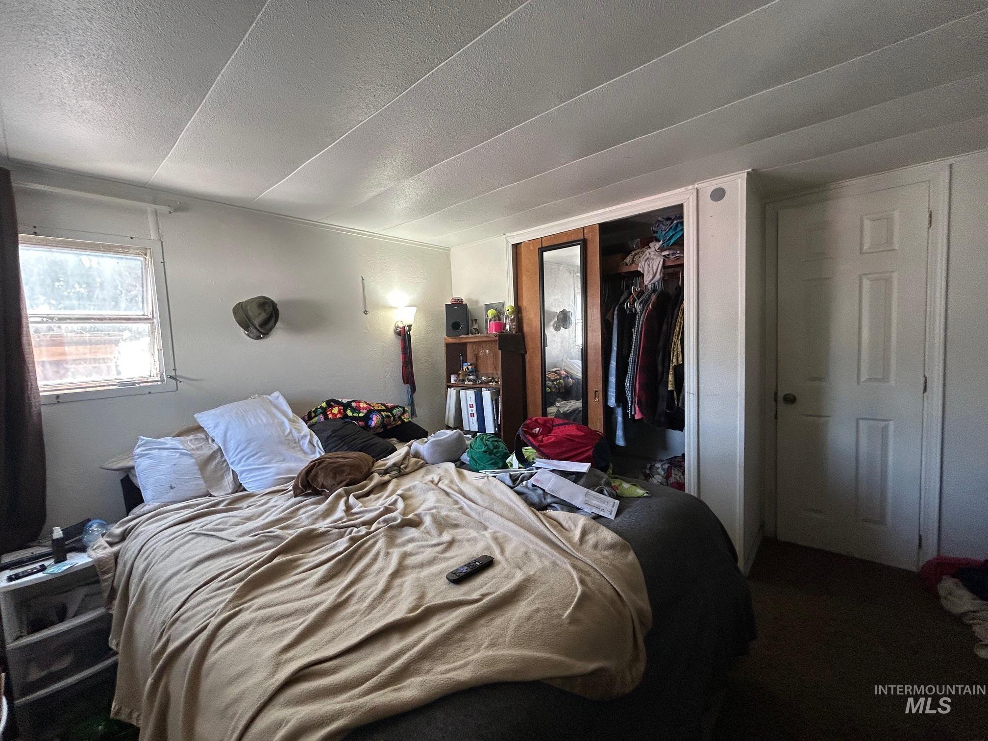 1383 Fair Street, Unit 7 Clarkston, WA 99403 - Photo 15 of 15 Bedroom with a textured ceiling, a closet, and carpet