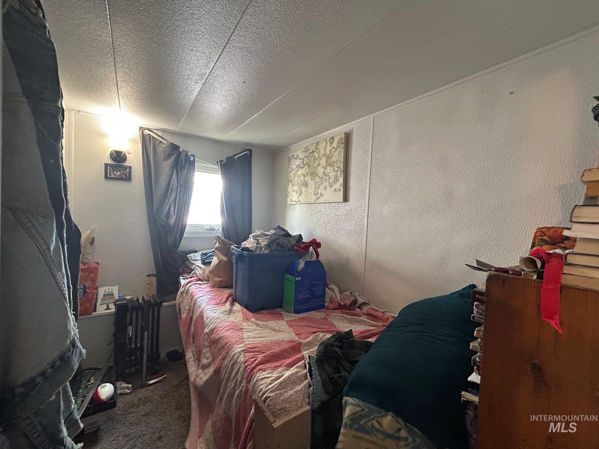 1383 Fair Street, Unit 7 Clarkston, WA 99403 - Photo 9 of 15 Carpeted bedroom with a textured wall and a textured ceiling