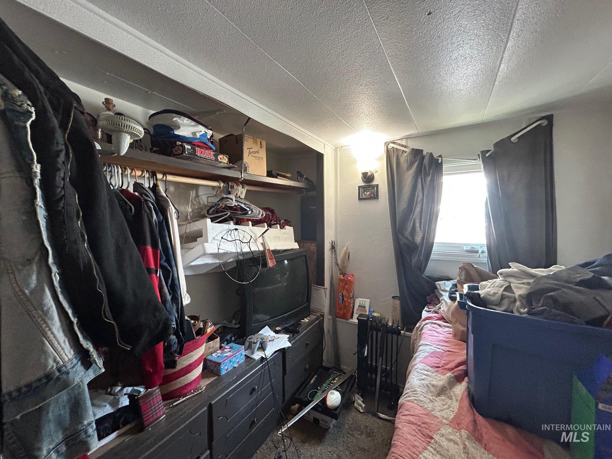 1383 Fair Street, Unit 7 Clarkston, WA 99403 - Photo 10 of 15 Carpeted bedroom featuring a textured ceiling