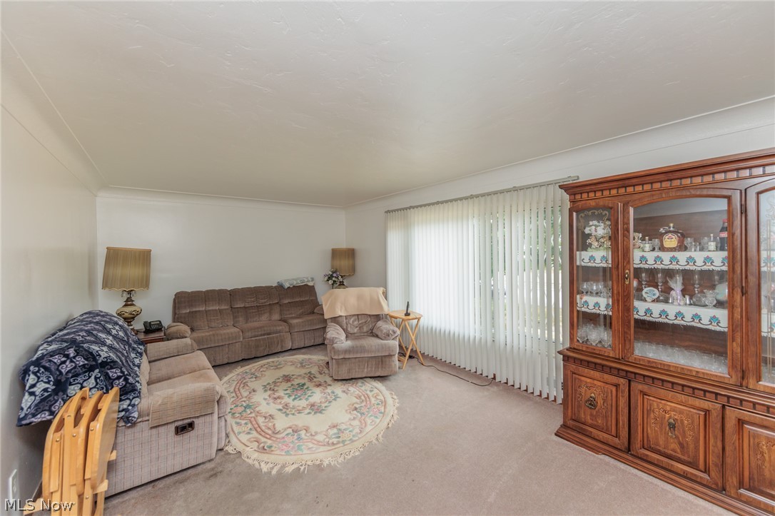 6147 Holburn Road Cleveland, OH 44129 - Photo 4 of 45 Carpeted living room with ornamental molding