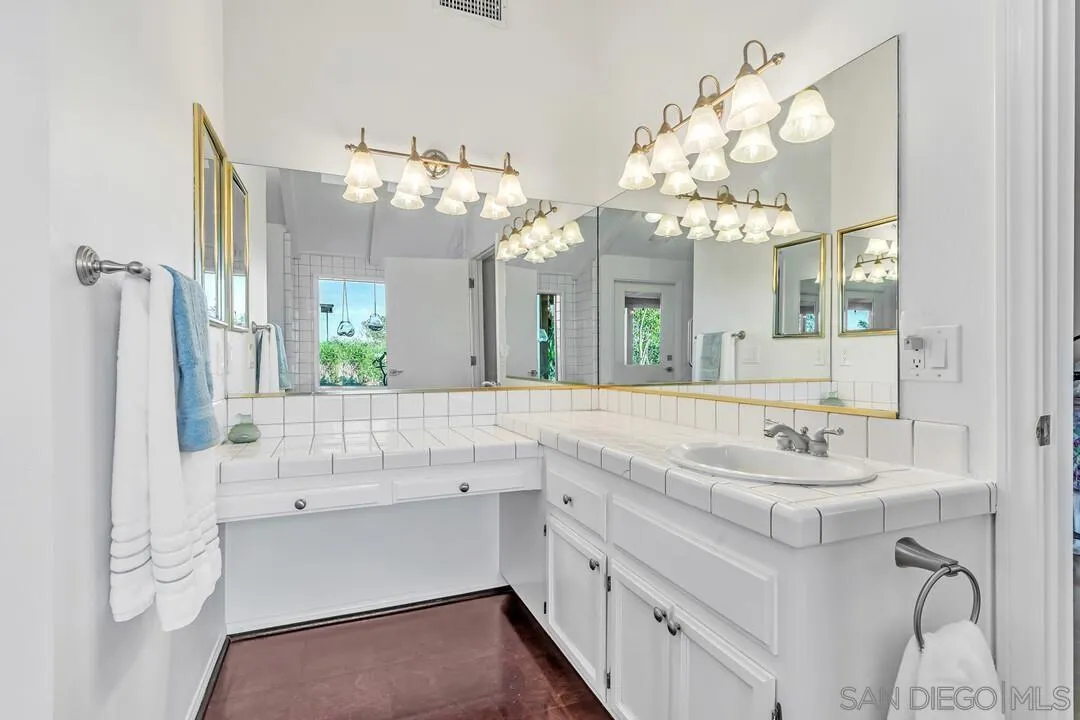 290 North Old Hill Road Fallbrook, CA 92028 - Photo 15 of 47 a bathroom with a sink vanity and a mirror
