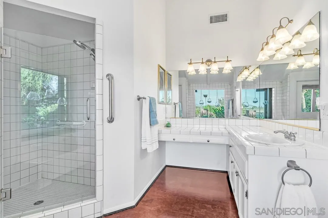 290 North Old Hill Road Fallbrook, CA 92028 - Photo 16 of 47 a bathroom with a sink a mirror and a shower