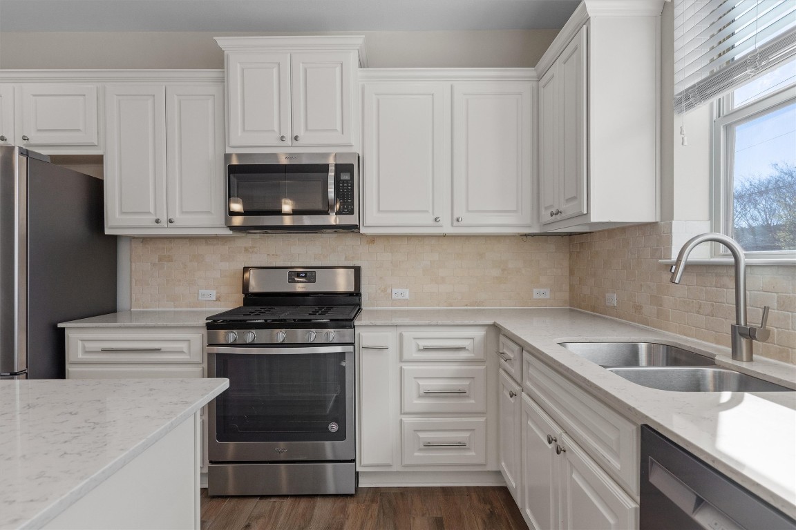9416 Hunter Lane Austin, TX 78748 - Photo 11 of 35 a kitchen with cabinets appliances and a sink