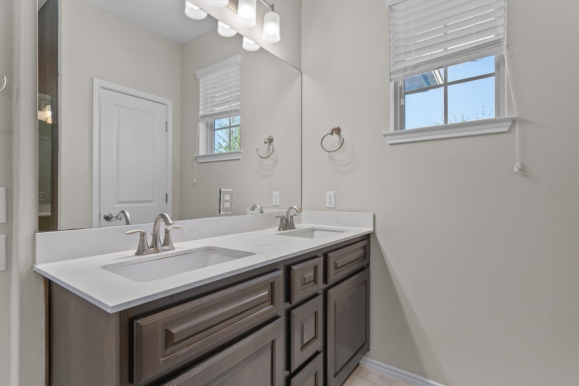 9416 Hunter Lane Austin, TX 78748 - Photo 22 of 35 a bathroom with a sink and a mirror