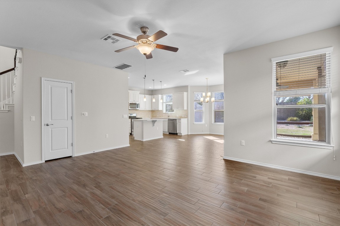 9416 Hunter Lane Austin, TX 78748 - Photo 6 of 35 a view of an empty room with wooden floor and a window