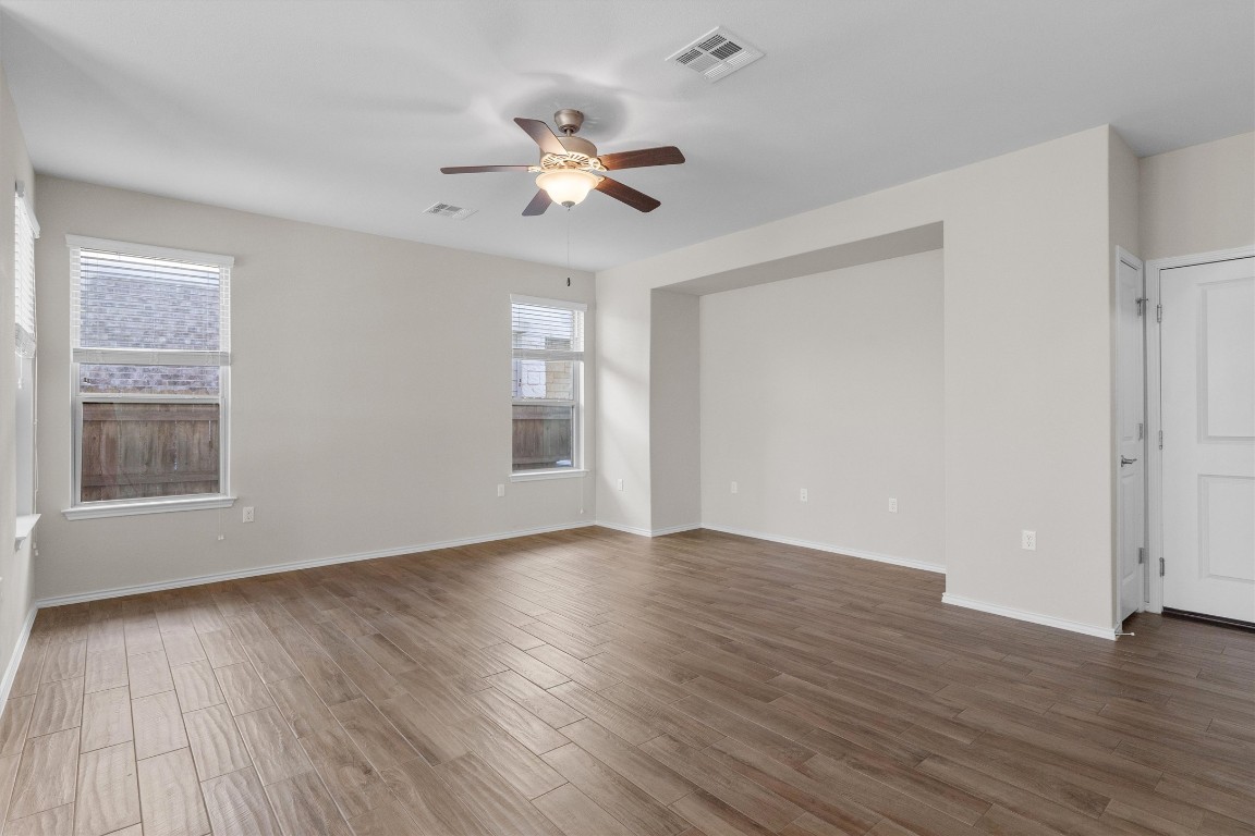 9416 Hunter Lane Austin, TX 78748 - Photo 8 of 35 a view of an empty room with wooden floor and a window