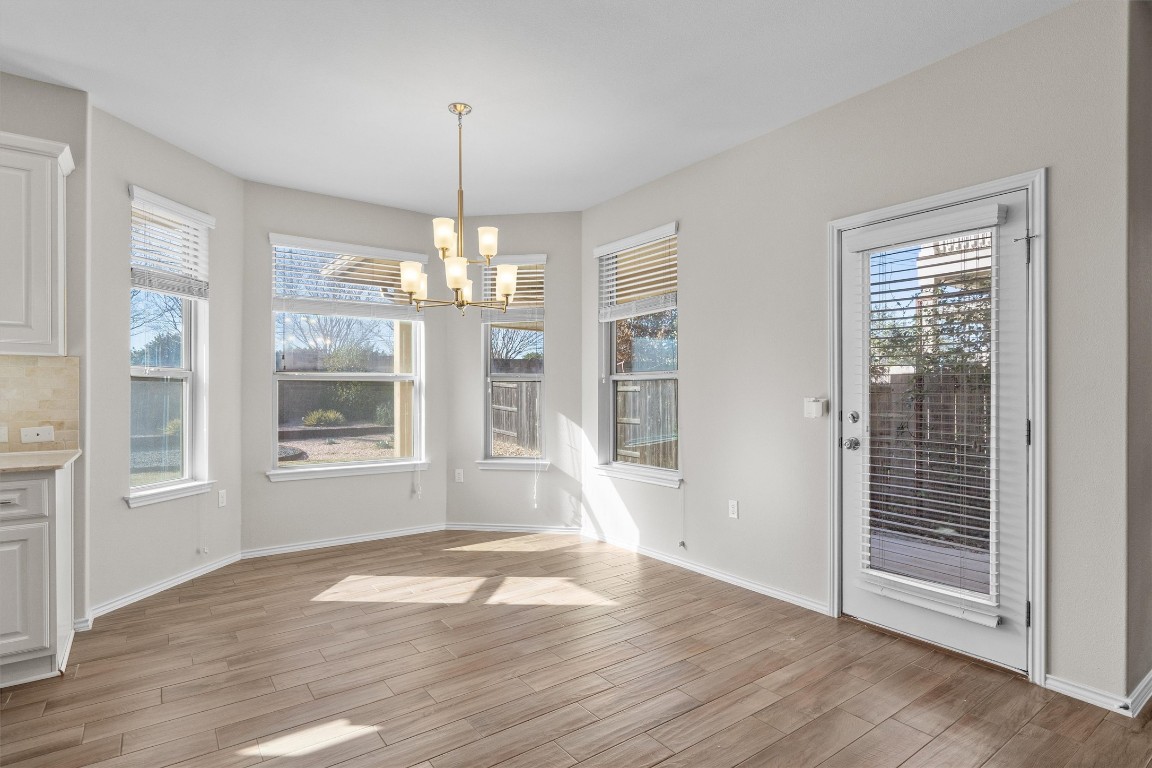 9416 Hunter Lane Austin, TX 78748 - Photo 9 of 35 an empty room with wooden floor and windows
