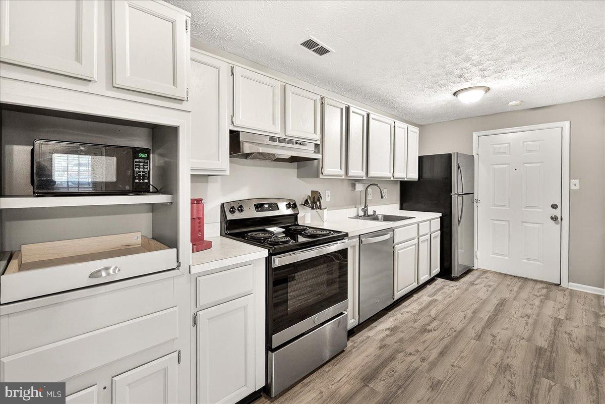 2141 Wainwright Court, Unit BA Frederick, MD 21702 - Photo 3 of 42 Modern kitchen with sleek white cabinetry.