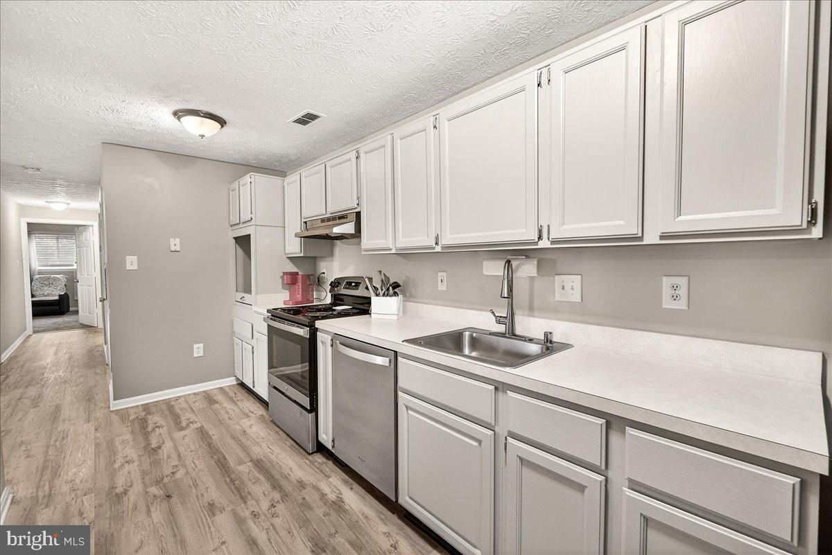 2141 Wainwright Court, Unit BA Frederick, MD 21702 - Photo 4 of 42 Modern kitchen with sleek white cabinetry.