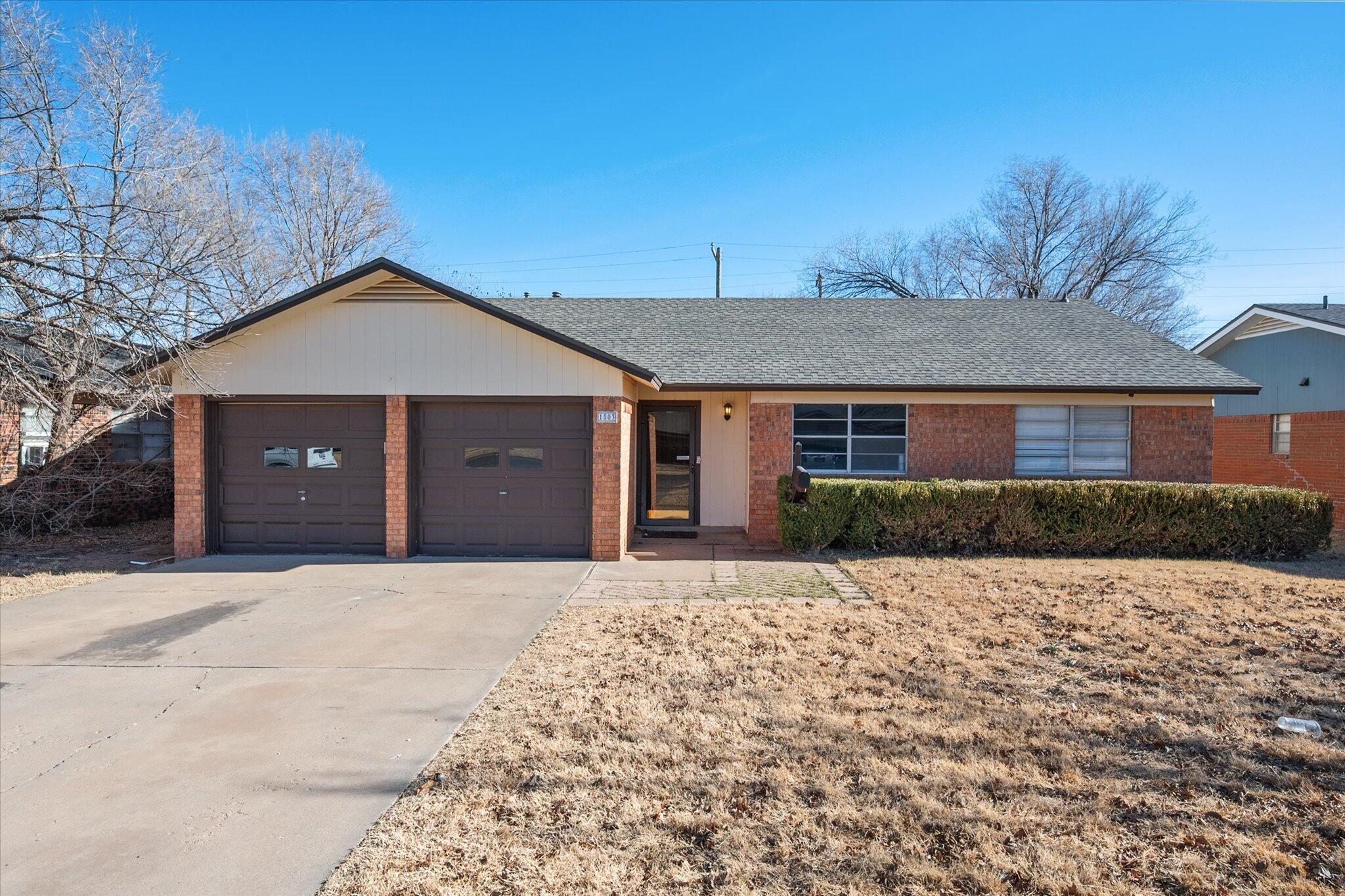 1503 Elkhart Avenue Lubbock, TX 79416 - Photo 1 of 28 a front view of a house with a yard