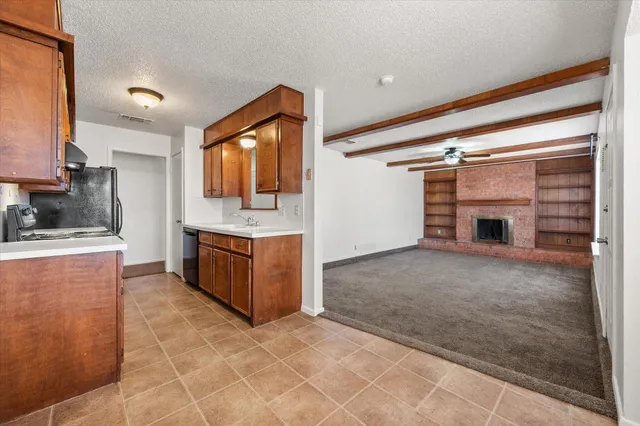 a large kitchen with a stove and a sink