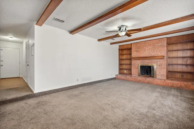 a view of empty room with fireplace