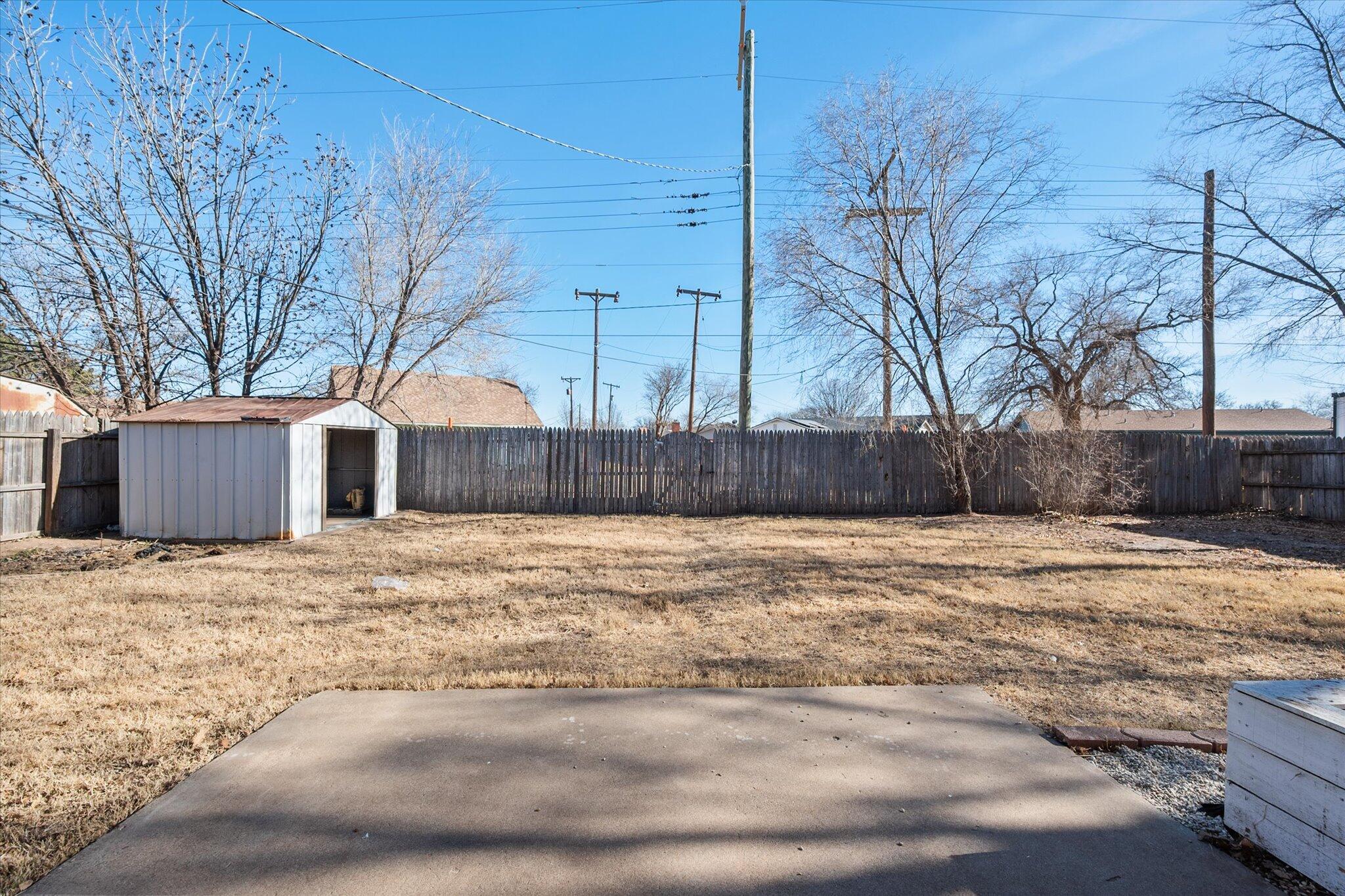 1503 Elkhart Avenue Lubbock, TX 79416 - Photo 25 of 28 a wooden fence with some trees in the background