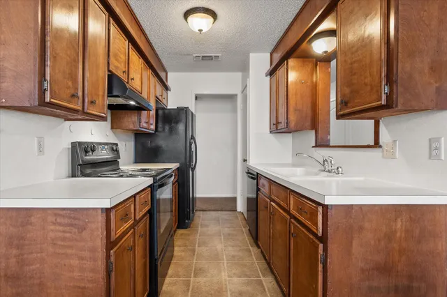 a kitchen with a sink and a refrigerator