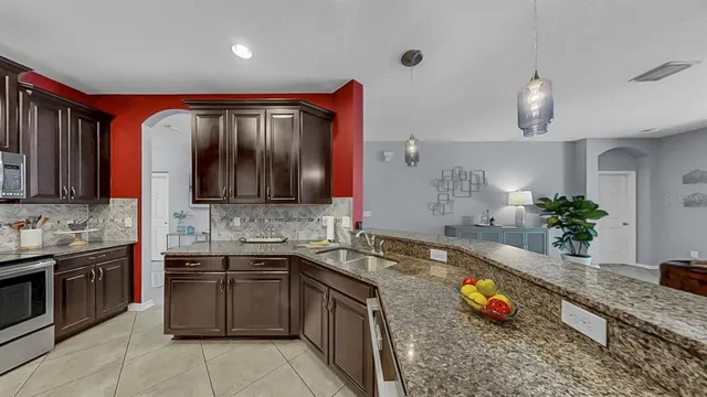 a kitchen with stainless steel appliances granite countertop a refrigerator and a sink