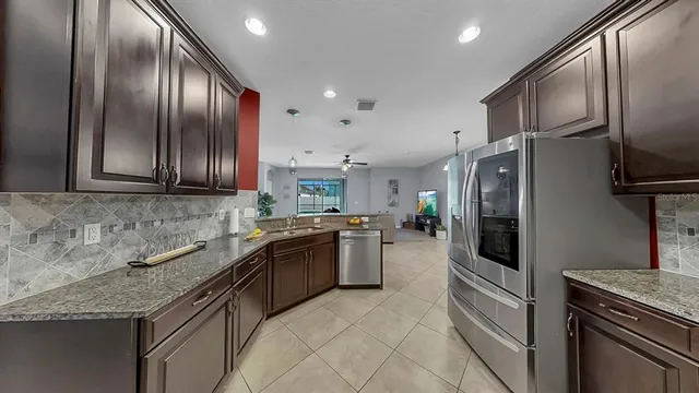 a kitchen with stainless steel appliances granite countertop a stove and a microwave