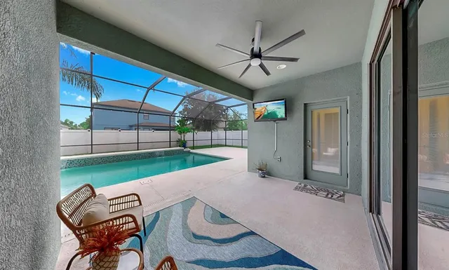 a view of a livingroom with furniture and a ceiling fan